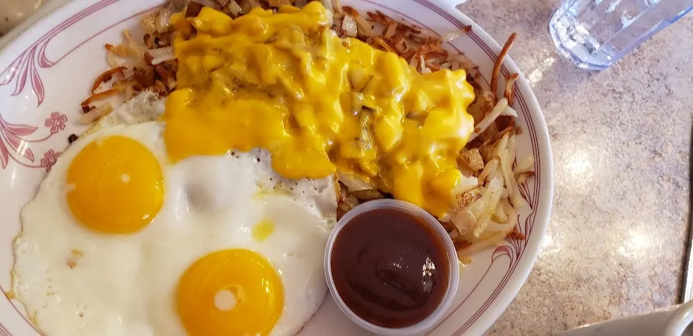 Sunnyside Up Eggs and Hash Browns with Cheese and Onions